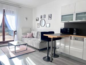 a living room with a couch and a table at Apartmán Lakeside in Český Krumlov