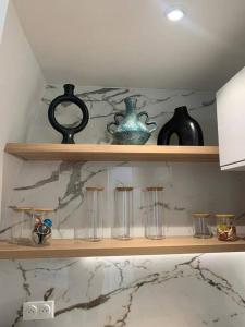 a shelf with vases and other items on it at Appartement Malesherbes Paris in Paris