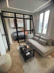 a living room with a couch and a table at Appartement Malesherbes Paris in Paris