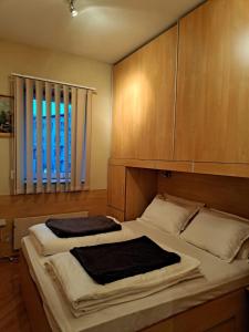 a bedroom with two beds and a large window at Centar 1 in Karlovac