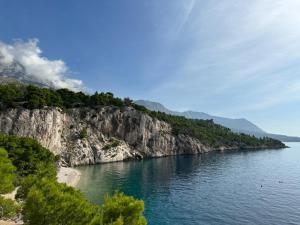 a view of a large body of water with a mountain at Uzelac apartment with pool in Makarska