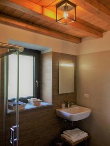 a bathroom with a sink and a mirror and a tub at Casa Martina in Zogno