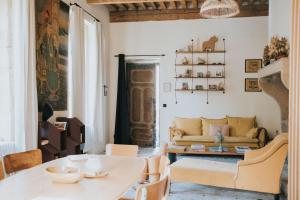 a living room with a couch and a table at Lyon Country House - Suites & Tour de Garde in Caluire-et-Cuire