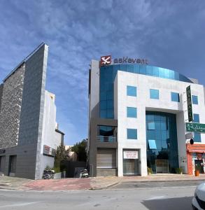 a building with a sign on the side of it at Lac Palace Luxury Apartment-2 Bdr in Tunis