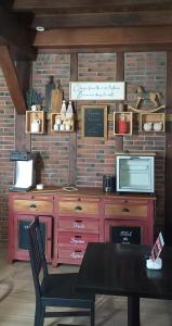 a room with a dresser and a table with a chair at Maison Errientania in Souraïde