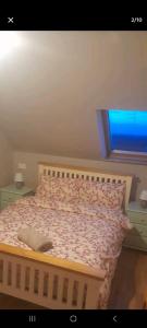 um quarto com uma cama com uma colcha rosa e uma janela em Atlantic lodge em Ahnagh Cross