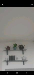 a shelf with pots and pans on a wall at Atlantic lodge in Ahnagh Cross