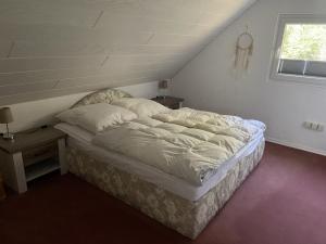 a large bed in a room with a window at Haus Waldesruh in Medebach