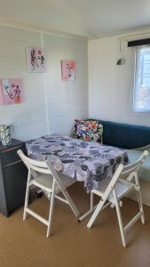 a room with a bed and two chairs at LE RHUYS, mobil home cosy proche des plages in Sarzeau