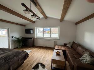 a living room with a couch and a table at Cityapartments Reutte in Reutte