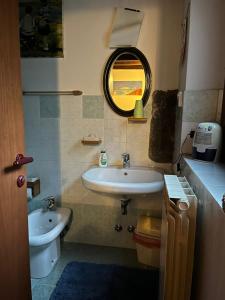 a bathroom with a sink and a mirror at B&B Mirna in Vaprio dʼAdda