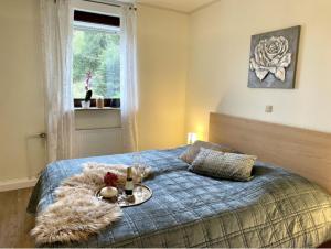 a bedroom with a bed with a tray of food on it at Ferienwohnung Am Kreuzberg in Schleiden