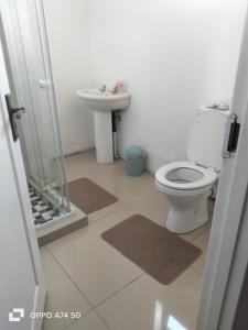 a bathroom with a toilet and a sink at 49 on Bristow in Roodepoort