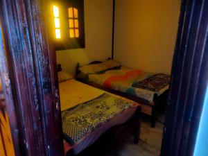 a small room with three beds and a window at See view Alexandria شقة فندقية zahraa elagami in Alexandria