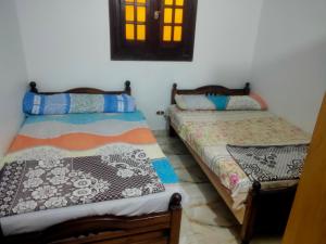 a bedroom with two beds in a room at See view Alexandria شقة فندقية zahraa elagami in Alexandria