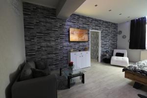 a living room with a brick wall at Wellness apartmán Apawell in Nezdenice