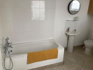 a bathroom with a bath tub and a sink at 50 meters from Beach. in Bognor Regis