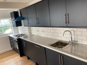 a kitchen with a sink and a stove at 50 meters from Beach. in Bognor Regis
