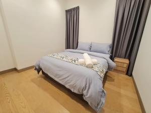 Un dormitorio con una cama con un objeto blanco. en Summer Suite KLCC, en Kuala Lumpur