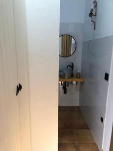 a bathroom with a sink and a mirror at Casa la Umbría in Elche de la Sierra