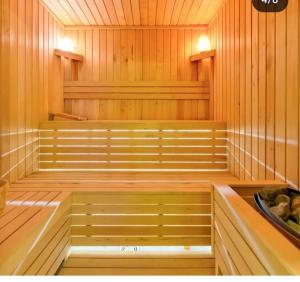 a sauna with wooden paneling and benches in it at Apartman TIO Binis in Zlatibor
