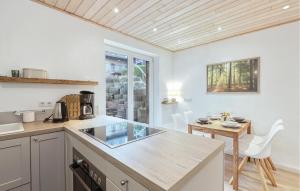 a kitchen with a counter and a table and chairs at Waldblick in Glücksburg