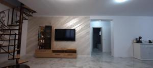 a living room with a flat screen tv on a wall at Casa Bellevue in Bacău