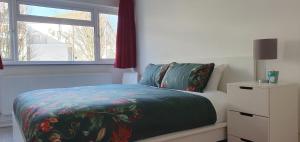 a bedroom with a bed and a window at LONDON EXPERIENCE in Eltham