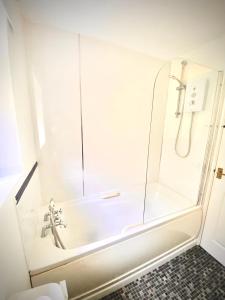 a shower in a bathroom with a glass door at The Snuggle in Symonds Yat