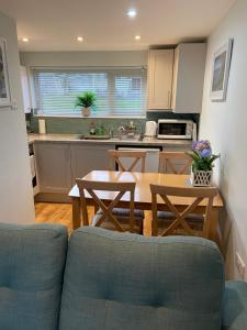 a kitchen with a couch and a table in a kitchen at Chalet 23 Widemouth Bay in Bude