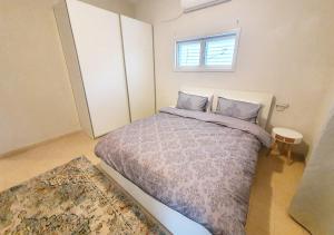 a bedroom with a bed and a window at Super Spacious 2BD Habima TLV heart, Balcony & Parking in Tel Aviv