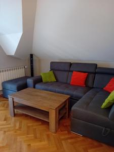 a living room with a couch and a coffee table at Orkana44F in Mszana Dolna