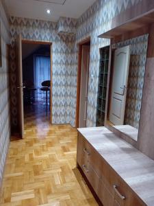 a kitchen with a wooden floor and a mirror at Orkana44F in Mszana Dolna