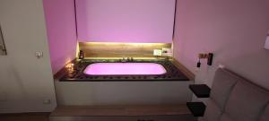 a bathroom with a bath tub with a pink light at Le casette in Monopoli