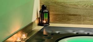 a bathroom with a sink and a bottle of soap at Le casette in Monopoli