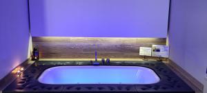 a bath tub with a blue light in a bathroom at Le casette in Monopoli