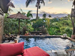 a swimming pool in a yard with a resort at OHANA Jungle Lodges in Les Avirons