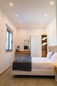 a bedroom with a large white bed and a window at VILLA KASABLANCA in Skala Rachoniou +66 photos