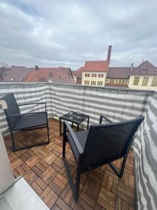 a patio with two chairs and a table on a roof at Wohlfühloase by Rent Rooms Rietz in Stein bei Nürnberg