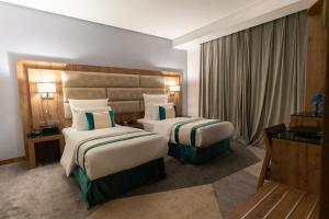 Postel nebo postele na pokoji v ubytování Rasia Hotel Jeddah