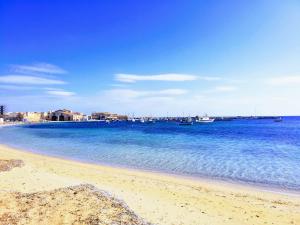 a view of a beach with boats in the water at Casa vacanza "Orchidea" in Marzamemi