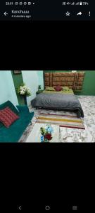 a picture of a bedroom with a bed and flowers at Varanasi homestay in Varanasi