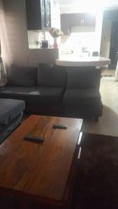 a living room with a couch and a table at Nelly Apartments in Mbale