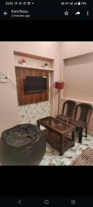 a living room with a couch and a table and chairs at Varanasi homestay in Varanasi