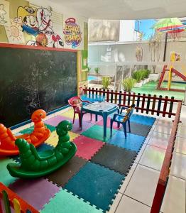 a classroom with a table and chairs and a chalkboard at Pousada Recanto do Cowboy in Penha