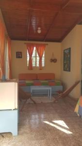 a living room with a couch and windows at Casa Sylvie in Sosúa