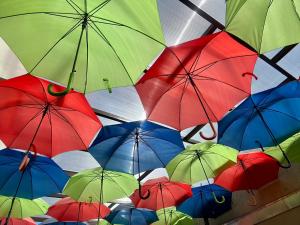 a bunch of colorful umbrellas hanging from a ceiling at Pousada Recanto do Cowboy in Penha