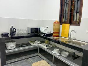 a kitchen with a sink and a counter top at Cactus Boralesgamuwa in Boralesgamuwa