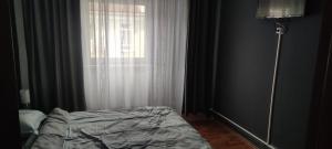 a bedroom with a bed in front of a window at Apartament în regim Hotelier in Cavnic