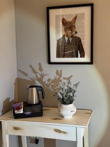 a picture of a dog in a suit on a table at The Coach House in Chedworth
